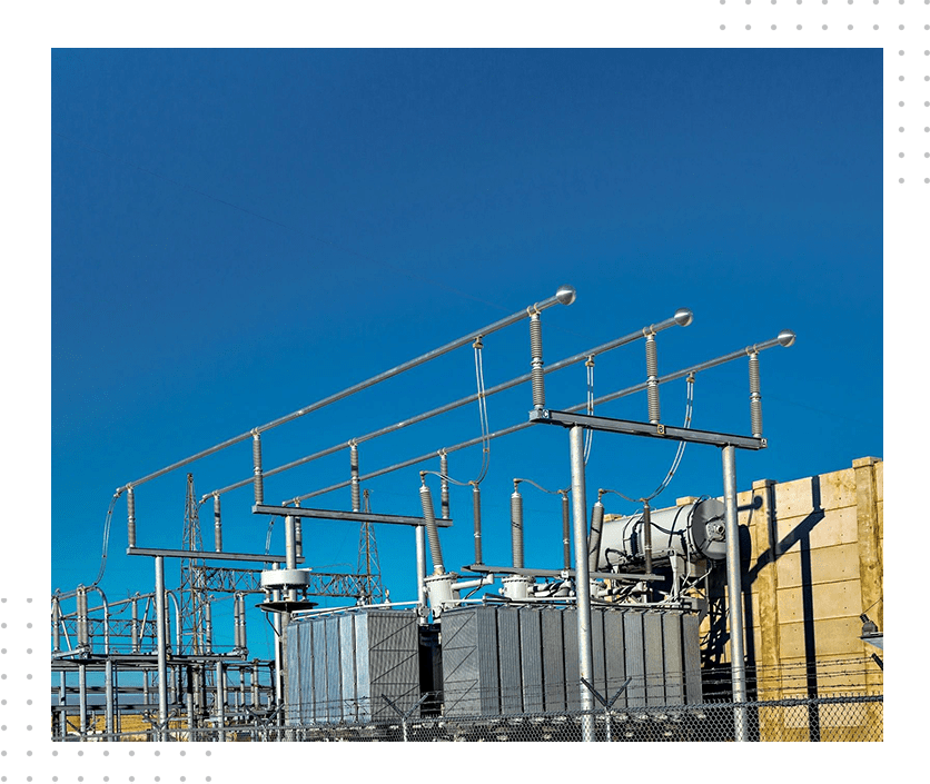 A power plant with many wires hanging from it.
