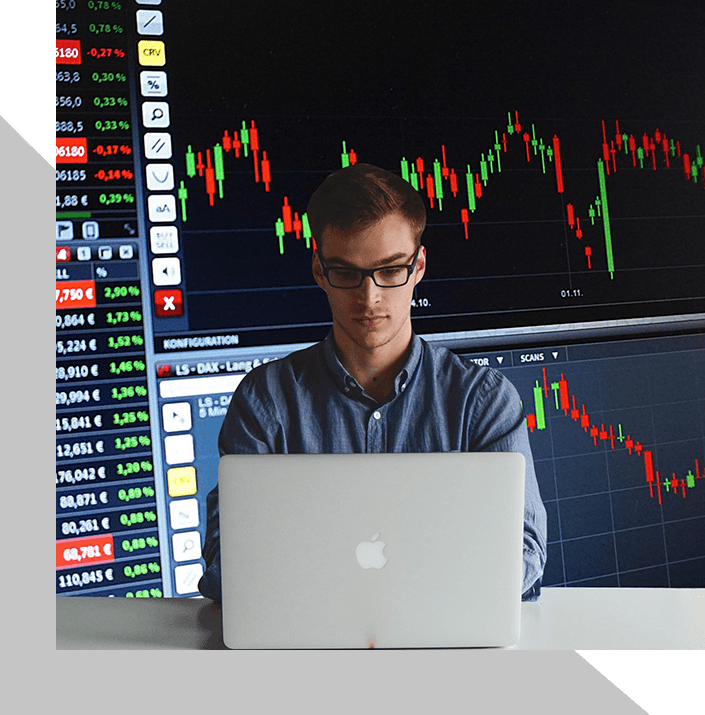 A man sitting at a desk with a laptop.